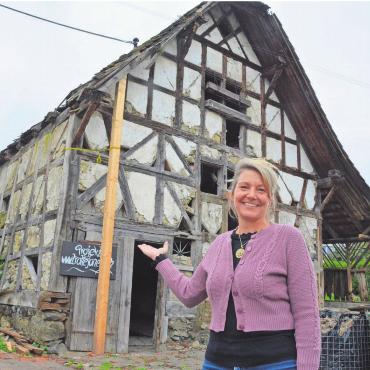 Zwischen Freude und Bürde - Martina Schiffer vor der Trotte im Zentrum Jonens. Mittlerweile ist das Gebäude eingerüstet. Bild: Annemarie Keusch