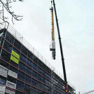 Ein Novum in der Region - Die 23 Meter hohe Stahlsäule wird vorsichtig in die neue Lagerhalle gehievt ...