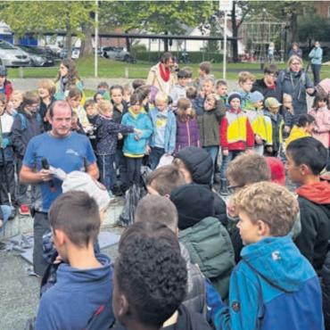 Bewusstsein für Umweltschutz stärken - Michel Kilchsperger, Leiter des Hausdienstes (Mitte mit Mikrofon), vermittelte den Kindern wertvolle Informationen über die Bedeutung des Recyclings. Bild: zg
