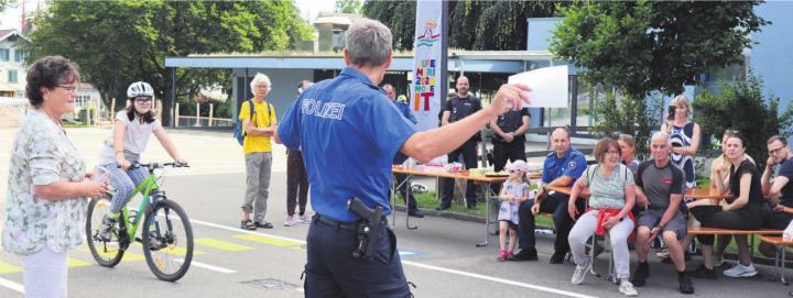 Harald Hirzel, mit dem Rücken im Bild, begrüsste die Gäste zur Eröffnung des Verkehrsgartens und wusste gleichzeitig die velofahrenden Kinder im Auge zu behalten. Bilder: vaw